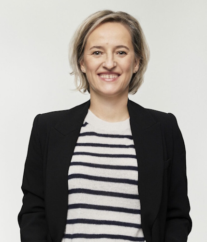 Portrait of Basia smiling, in black jacket