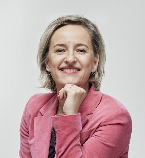 Portrait of Basia smiling, in pink jacket